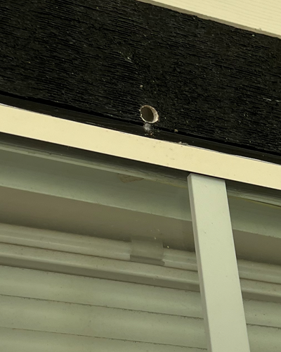 Photo of the hole in the upper window sill.