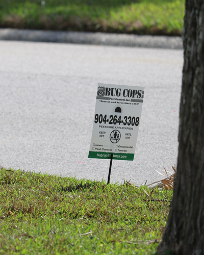 Bug Cops pesticide application notification sign placed at a treated property