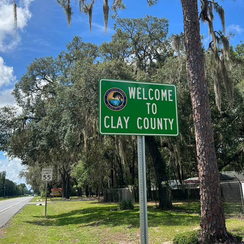 Green Welcome to Clay County road sign in Florida
