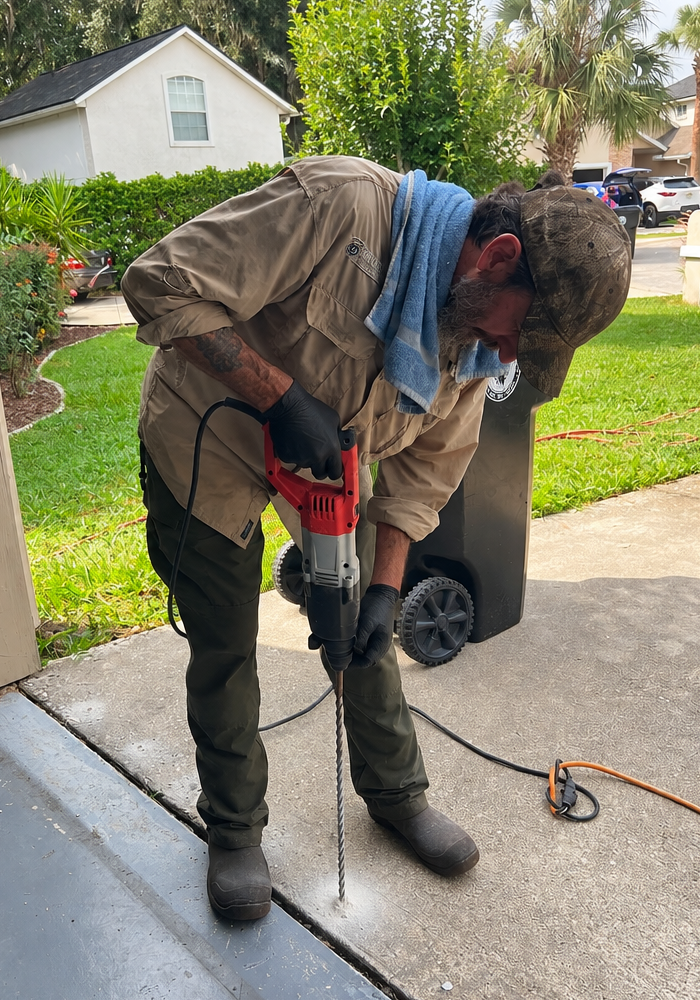 Drilling concrete for termite protection services